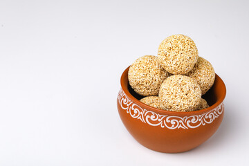 Indian sweet for traditional festival makar sankranti :Rajgira laddu made from Amaranth seed in Bowl on white background