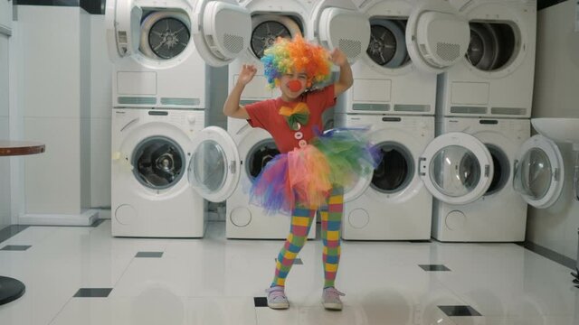 Happy Clown Little Girl Dancing And Have Fun In the Laundry Room. Little Child Clown Enjoying Dance, Having Fun Together, Party. Floss Dance Viral, Flossing.