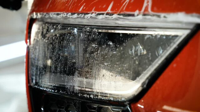 Close up to PPF installation process on a front rear headlight and bamper. PPF is a Paint Protection Film which protect paint