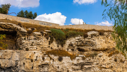 Skull Hill rock escarpment - Calvary or Golgotha - considered as actual place of crucifixion of Jesus Christ near Old City of Jerusalem, Israel