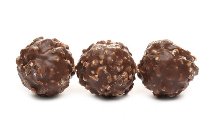 Round hazelnut chocolates isolated on white background