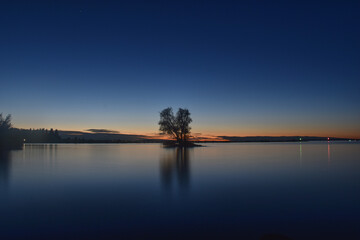 Small island with tree in last light of day