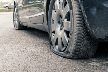 flat car tire close up, punctured wheel