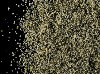 Peeled hemp seed isolated on black background, top view