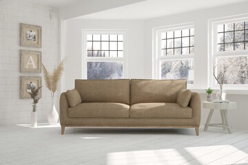 White living room with sofa and winter landscape in window. Scandinavian interior design. 3D illustration