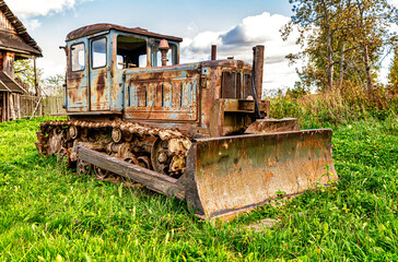 Old soviet arable rusty tractor