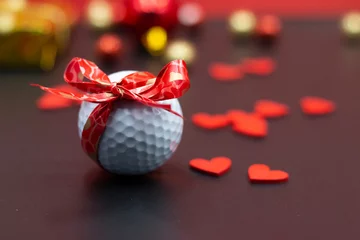 Rollo Golf ball with red ribbon for Valentine's Day  © thaninee