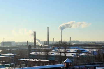 Obraz premium Man-made landscape, winter clear day smoking factory chimneys