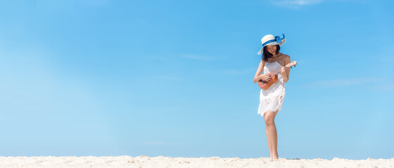 Lifestyle young woman relax on the summer beach.  Asia tourism people  playing guitar on beach in...