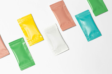Close-up composition of colored sachets on a white background.