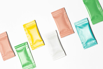 Close-up composition of colored sachets on a white background.