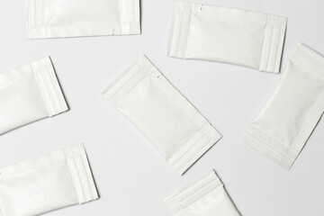 Close-up composition of white sachets on a white background.