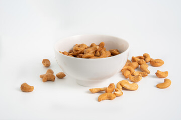 isoloated roasted cashew nuts in white crockery