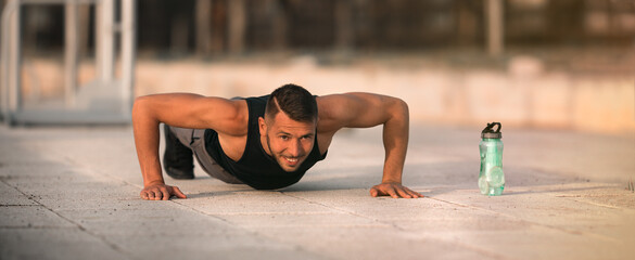 Sporty man doing push ups. Workout exercise. Training outdoor. Sports and fitness concept