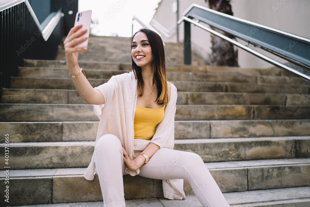 Poster cheerful hipster girl shooting influence vlog during travelling time for creating funny content, joy