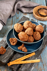 Chocolate coconuts. Chocolate balls with coconut. Chocolate candies or cookies with coconut, cinnamon and powdered sugar