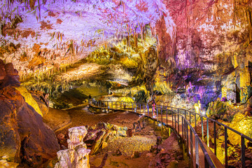 Pathway in Prometheus cave with beautiful colorful structures and formations