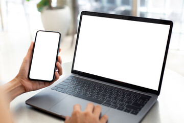 computer screen,cell phone blank mockup.hand woman work using laptop texting mobile.with white background for advertising,contact business search information on desk in cafe.marketing,design