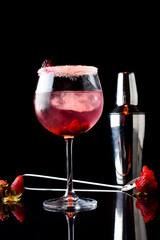drinks in glass and glass with lemon, red berries and strawberries with shaker in elegant background