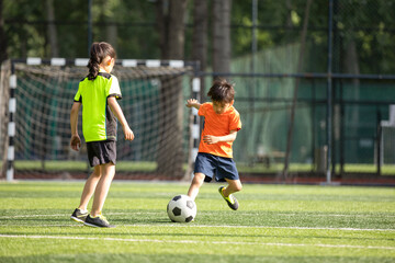 Children playing football on field