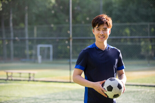 Young man playing football on field