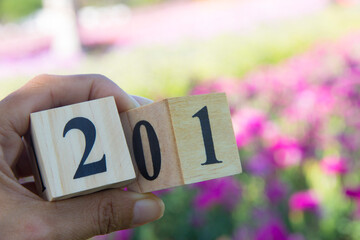 concept changing year from 2020 to 2021.A woman's hand flipping over a wooden block number 20 to 21
