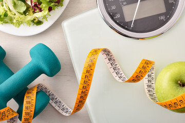 Conceptual healthy life background with dumbbell scales and healthy food - obrazy, fototapety, plakaty