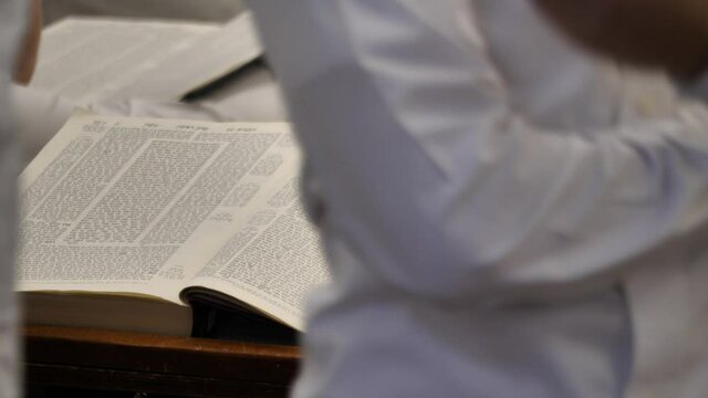 Opened Torah on the school desk, studying Judaism tradition and holy scripts