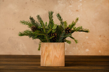 Bouquet of fir branches in eco bag on beige background. Concept eco-friendly and zero waste.