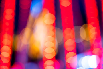 Cozy evening in the festive city. Blurred image of Shining Christmas lights, light garlands for...