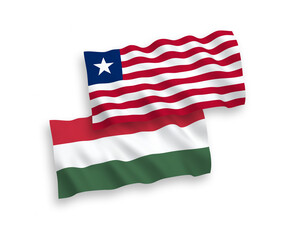 Obraz premium National vector fabric wave flags of Liberia and Hungary isolated on white background. 1 to 2 proportion.