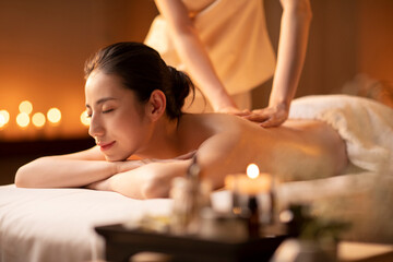 Young woman receiving back massage at spa center