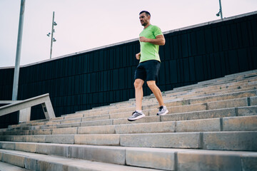 Caucasian male jogger have effort cardio training at urban settings feeling energy and vitality for...