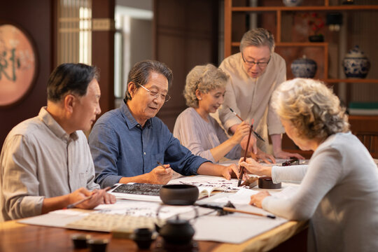 Happy friends practicing calligraphy together