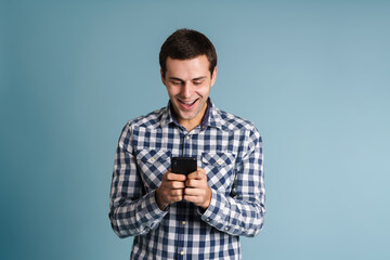 Handsome young man using mobile phone isolated