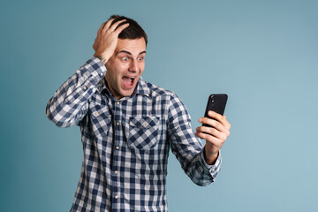 Handsome young man using mobile phone isolated