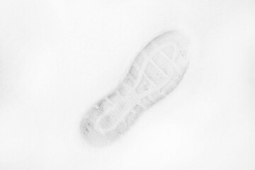 Top view of the footprint of shoes /boots on fresh snow. The winter season.