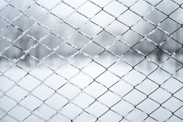 Metal wired fence under a snow - texture background