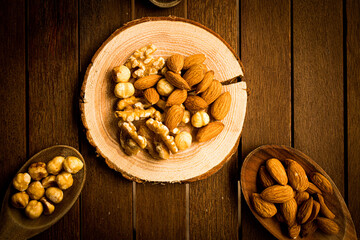 mix of almonds, walnuts and hazelnuts on a wooden table