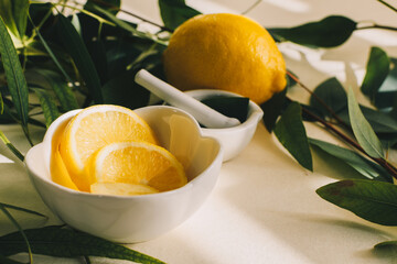 Lemon and eucalyptus leaves in small white ceramic mortar © Marcela Ruty Romero