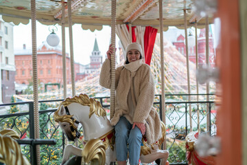 Content woman on carousel in park