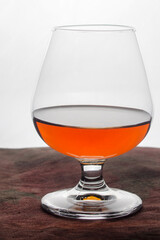 glass of cognac close-up, on a light background