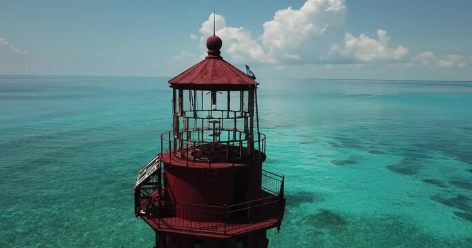 Close up wrap around drone shot of American Shoal Lighthouse 6.5 nautical miles off the coast of the Florida Keys near Sugarloaf Key,.