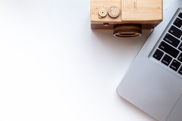 Working table with computer laptop and music box camera with copy space on white desk background, Top view style, Minimal workspace, business Concept