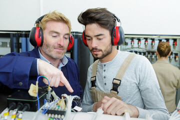 two workers fixing an issue