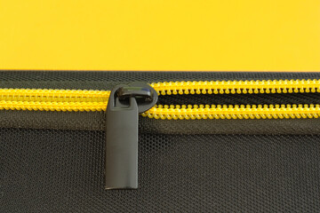 Yellow zipper close-up. Modern grey and yellow colors, copy space. © Vitezslav Vylicil