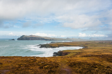 Scenic landscape with atlantic ocean shore, many mountains tops, hills and picturesque irish village during winter autumn season in Ireland. Concepts: season, outdoors, travel, landscape