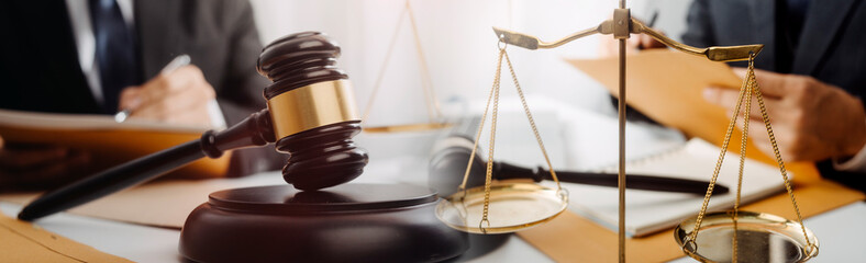 Business and lawyers discussing contract papers with brass scale on desk in office. Law, legal...