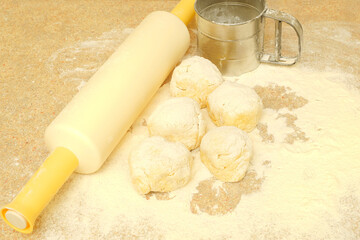 Sifting flour with a mechanical sieve. Dough and rolling pin. DIY.