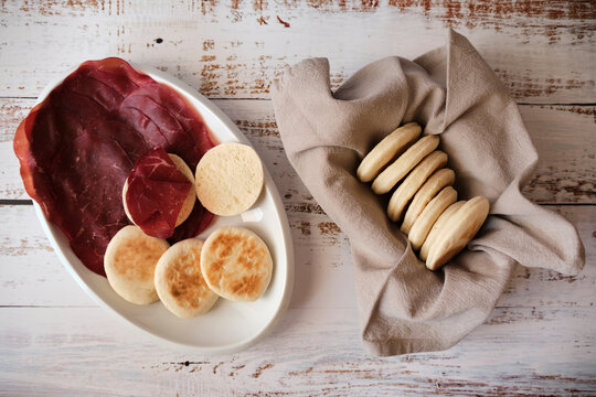 Typical Italian food TIGELLA on white dish with air-dried salted meat called BRESAOLA